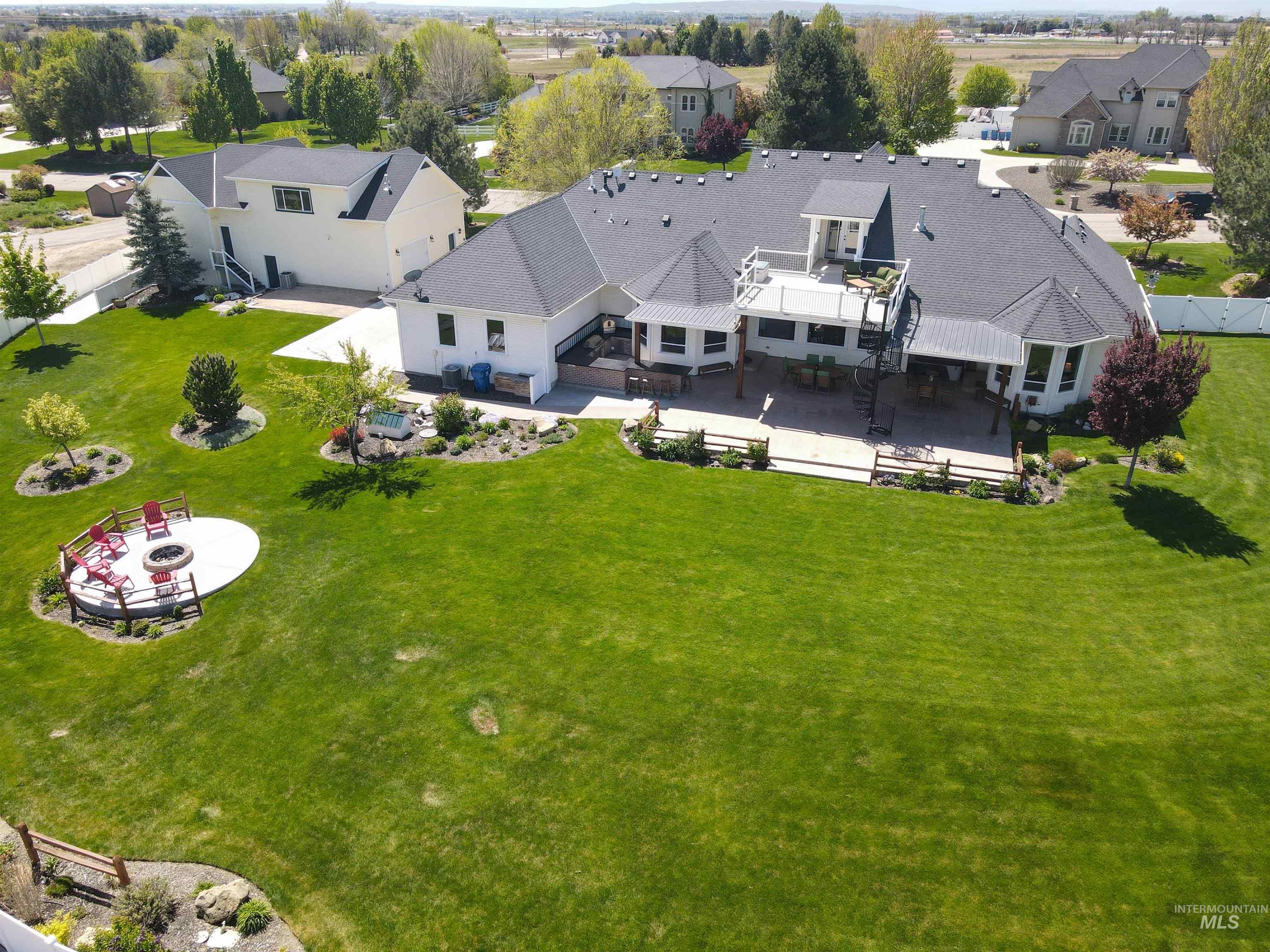 414 East Shafer View Drive Meridian, ID 83642 - Photo 47 of 50 Expansive fully fenced backyard has a wood burning firepit area w/designated seating, a wood structure for hanging a hammock stays, pressurized irrigation is included in HOA dues, individual well, septic, exterior wi-fi cameras, EZ to maintain flowerbeds
