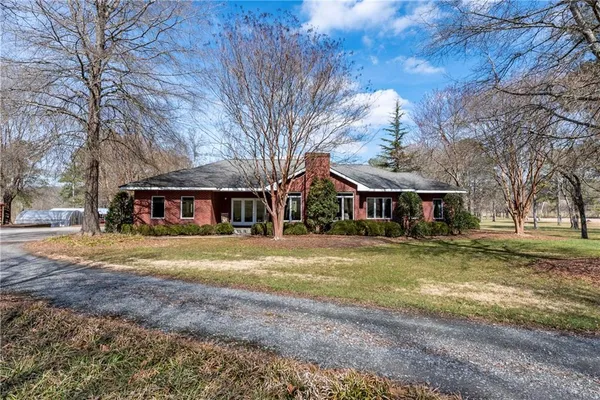 a view of a big house with large trees and a big yard