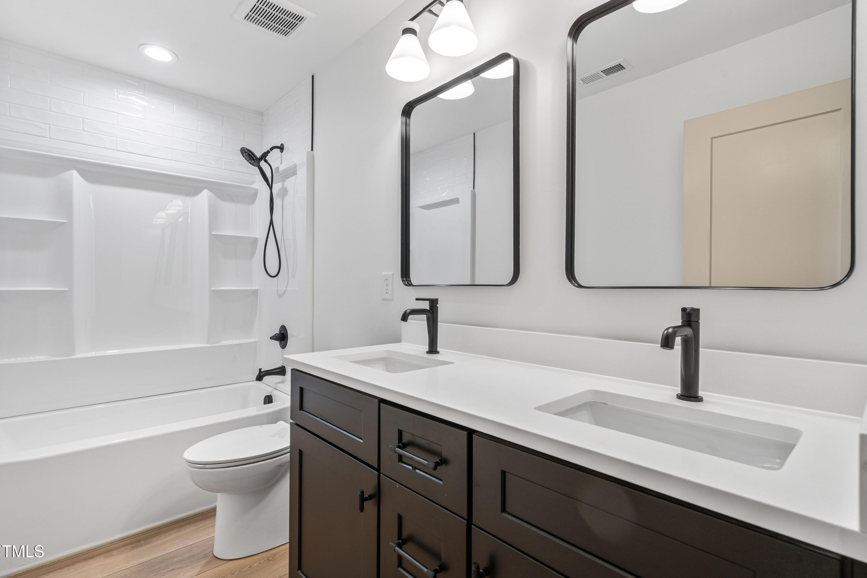 312 Russ Road Smithfield, NC 27577 - Photo 37 of 62 a bathroom with a double vanity sink toilet and shower