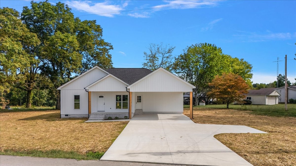58 Jordan Road Lawrenceburg, TN 38464 - Photo 1 of 31 a front view of a house with a yard and trees