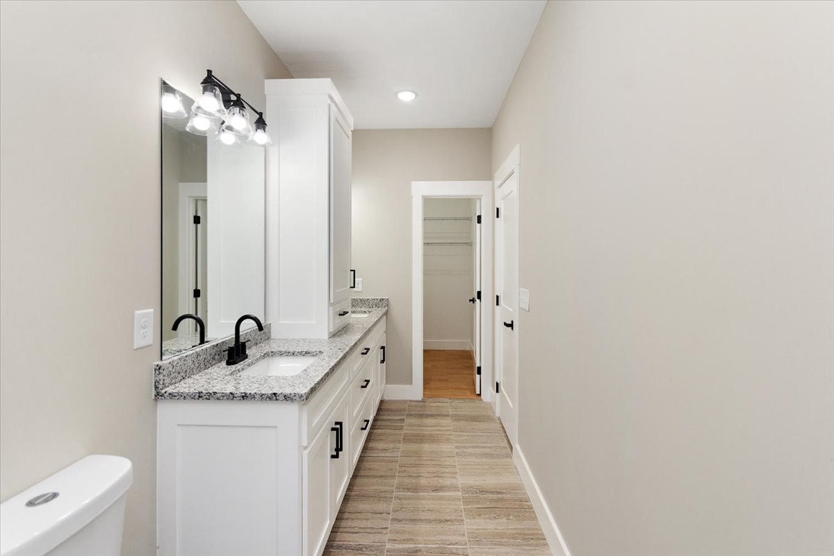 58 Jordan Road Lawrenceburg, TN 38464 - Photo 19 of 31 a en suite bathroom with a granite countertop sink and a mirror