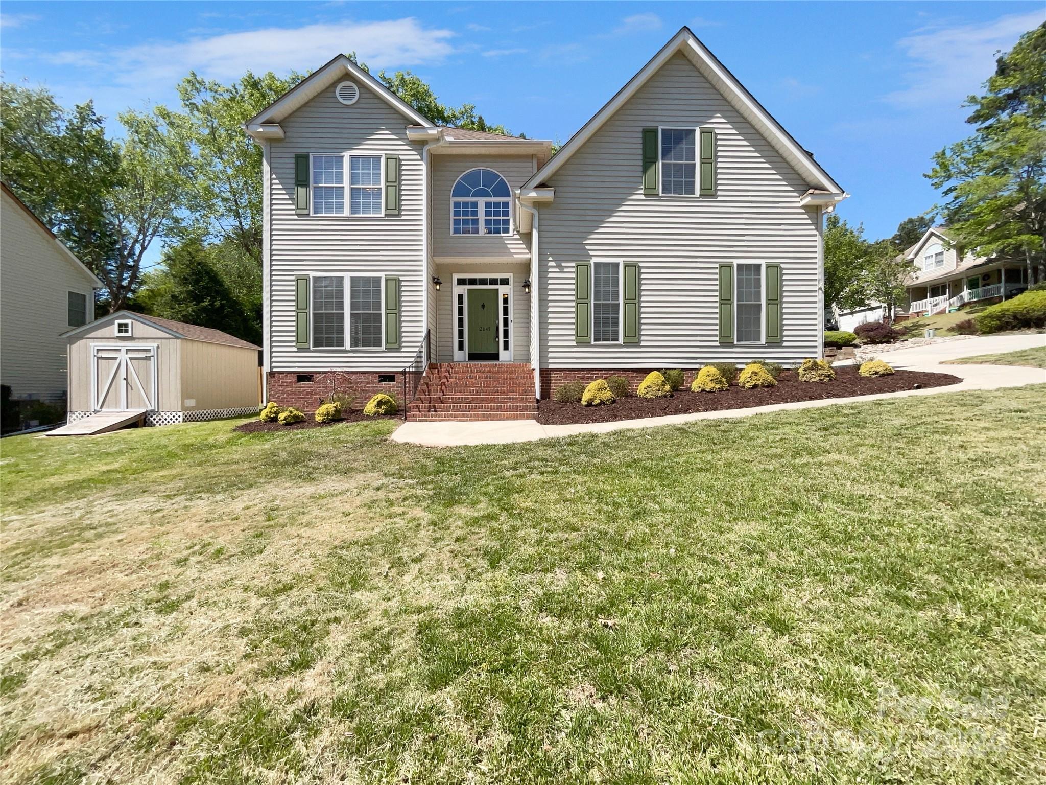 12047 Spinnaker Drive Fort Mill, SC 29708 - Photo 1 of 17 a front view of a house with a yard and garage
