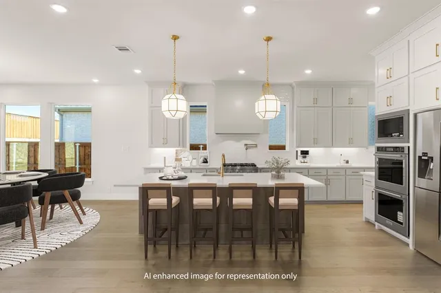 a large kitchen with kitchen island a dining table and chairs
