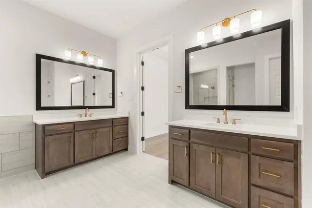 a bathroom with a double vanity sink and mirror