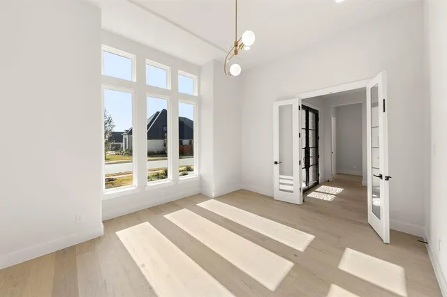 an empty room with closet and wooden door