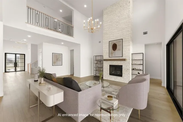 a living room with furniture a fireplace and a chandelier