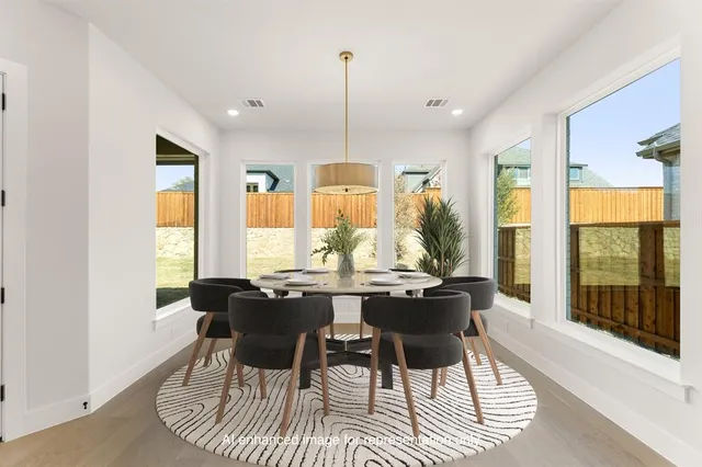 a dining room with furniture a chandelier and wooden floor
