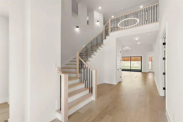 a view of staircase with white walls and a window