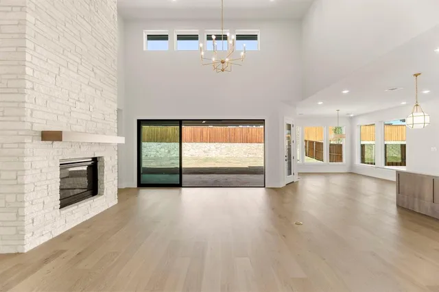 a view of empty room with wooden floor and fireplace