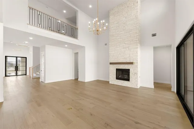a view of an empty room with a fireplace and a window
