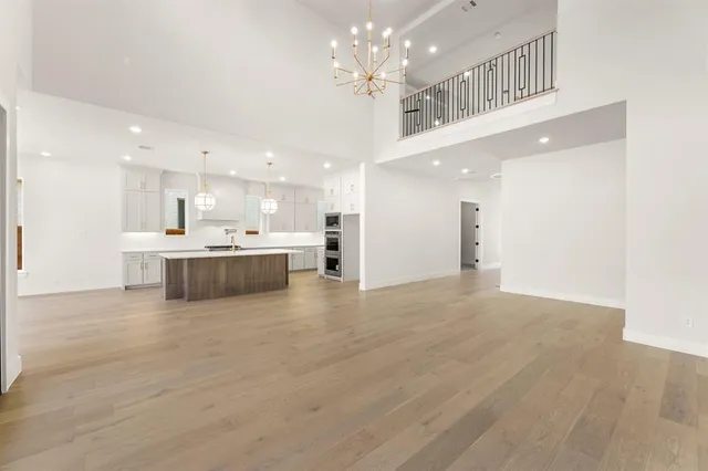 a view of kitchen with kitchen island a sink and a stove