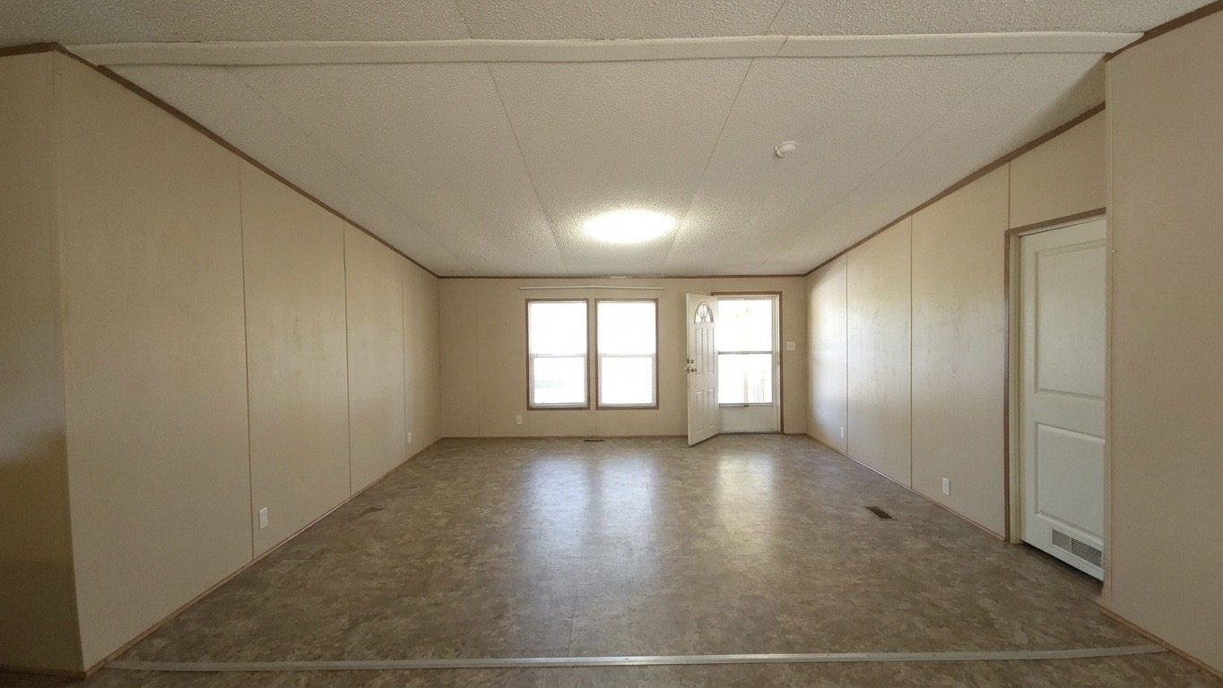 305 Thompson Road Dale, TX 78616 - Photo 8 of 11 Generous open space features durable vinyl flooring and natural light from multiple windows.