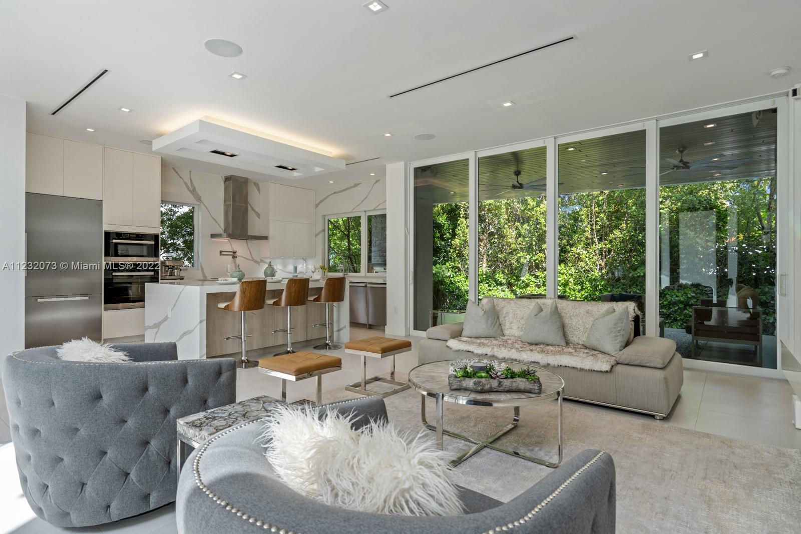 4610 Alton Road Miami Beach, FL 33140 - Photo 12 of 38 a living room with furniture and a large window
