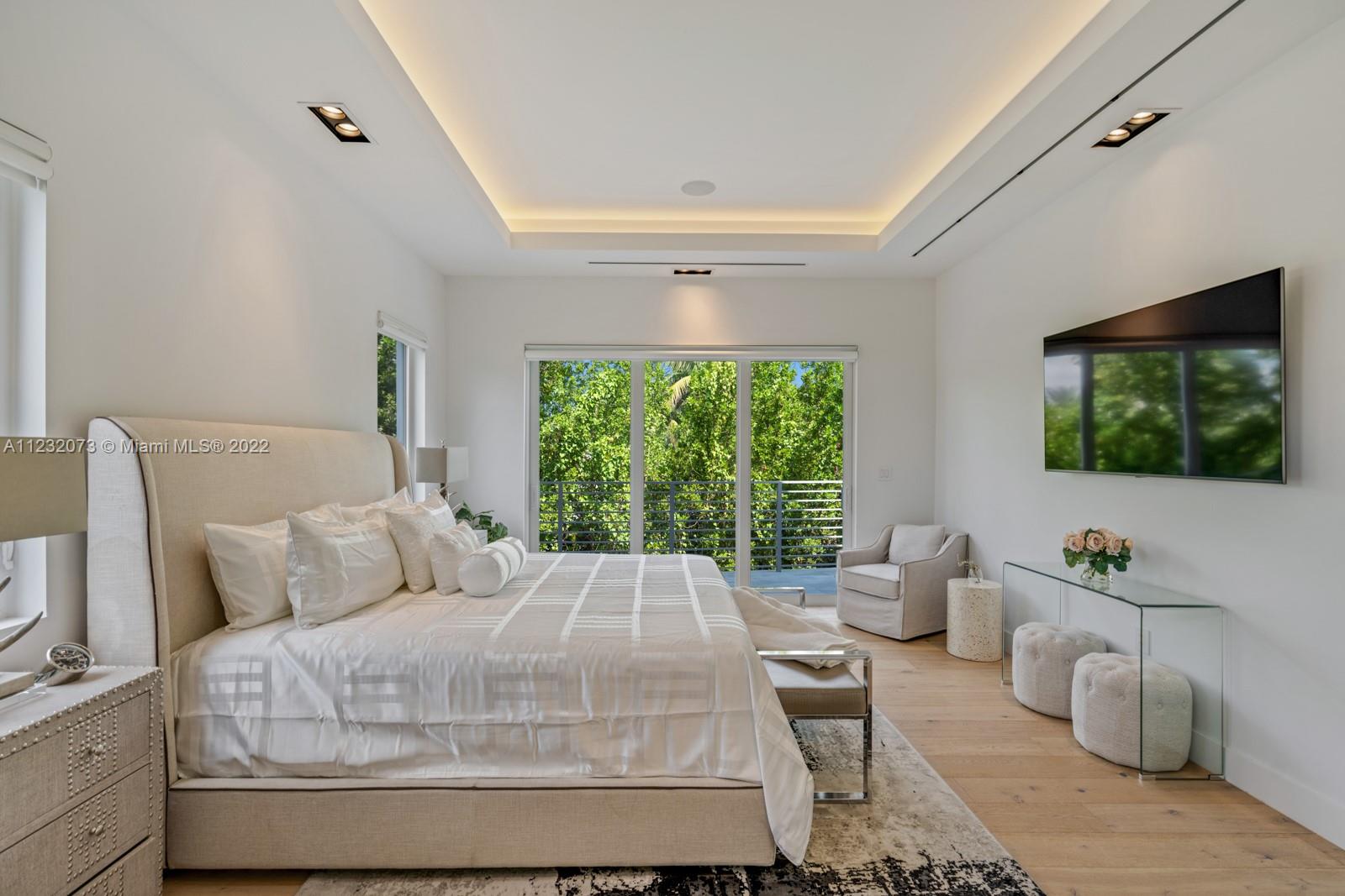 4610 Alton Road Miami Beach, FL 33140 - Photo 13 of 38 a bedroom with a large bed and a window