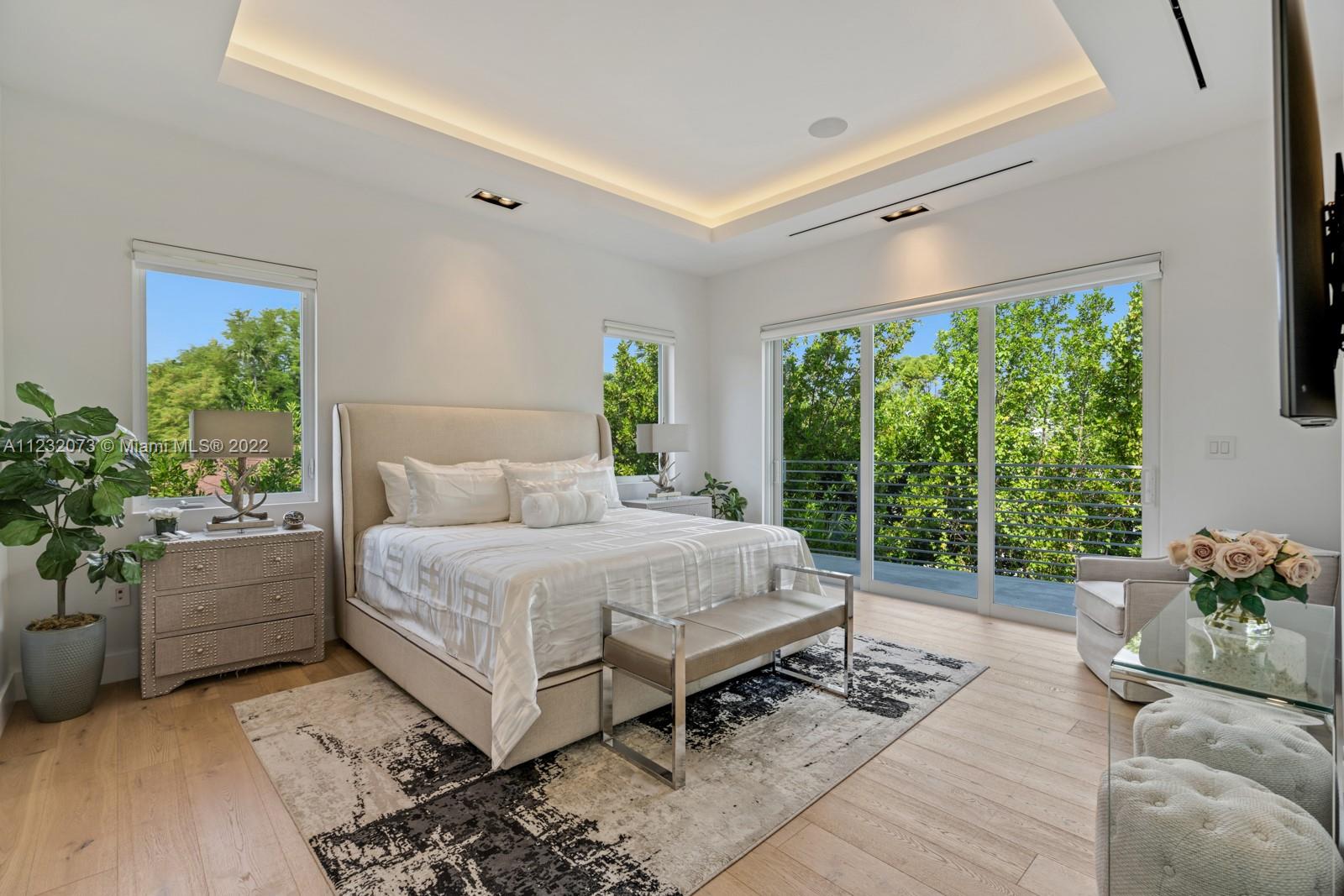 4610 Alton Road Miami Beach, FL 33140 - Photo 14 of 38 a bed sitting in a spacious bedroom next to a window