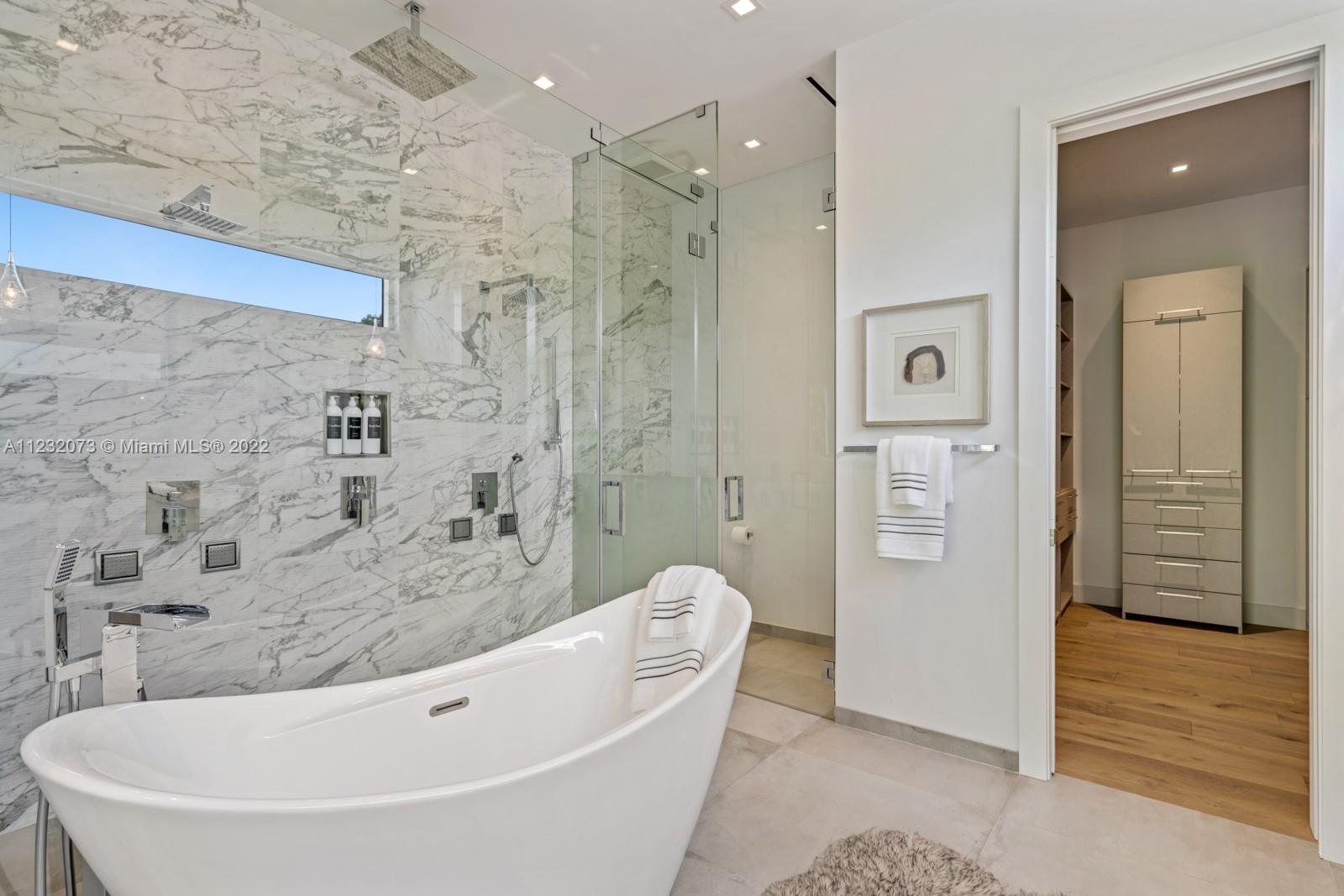 4610 Alton Road Miami Beach, FL 33140 - Photo 16 of 38 a bathroom with a bathtub and a shower