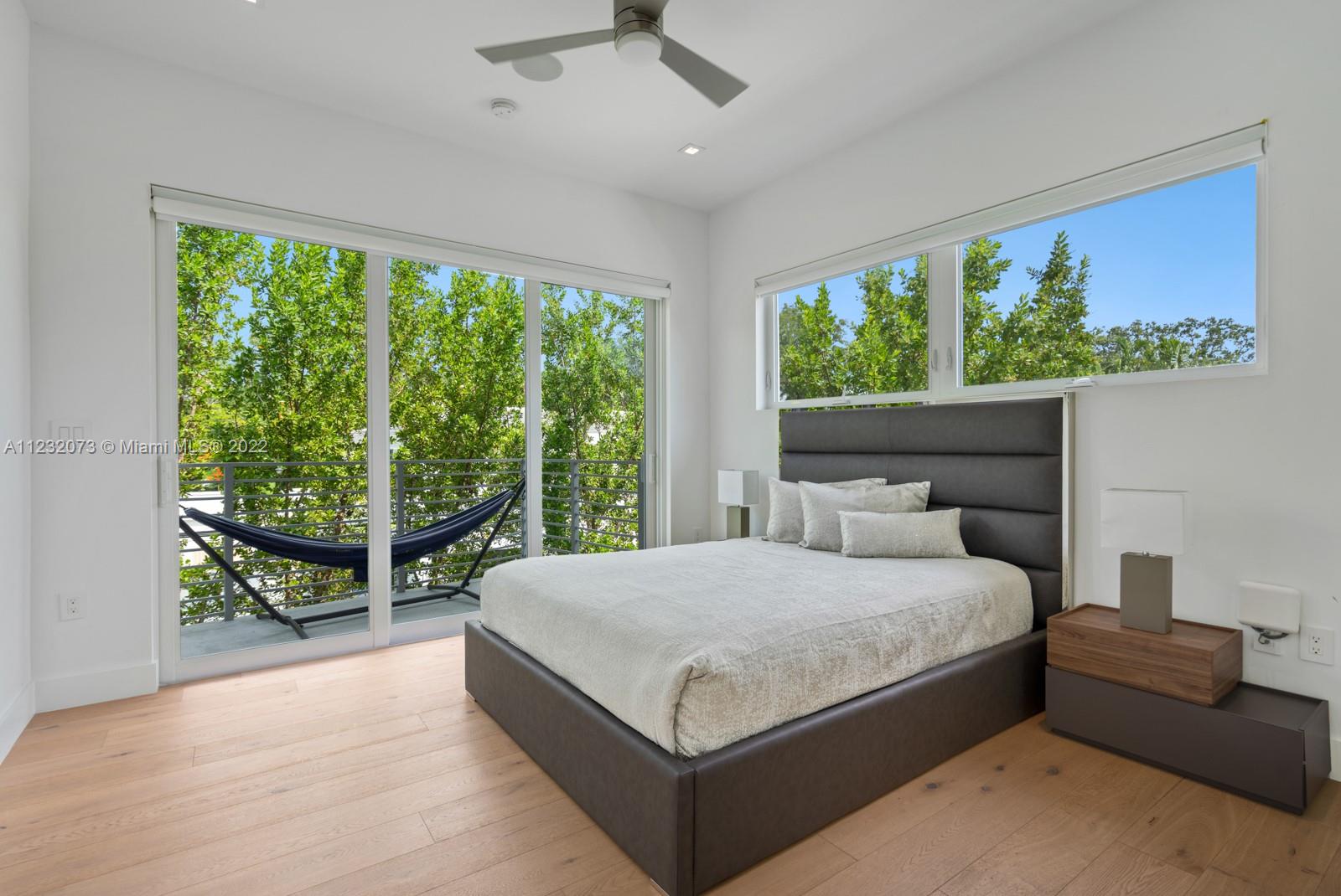 4610 Alton Road Miami Beach, FL 33140 - Photo 20 of 38 a bedroom with a large bed and a couch