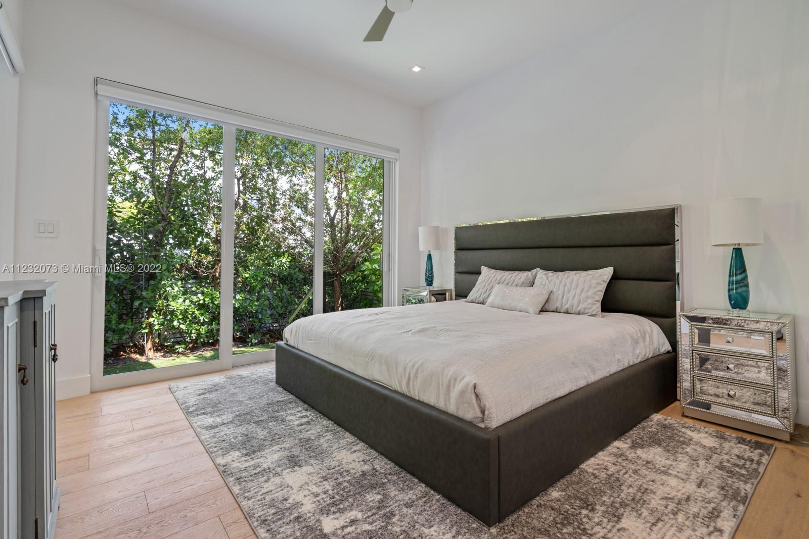 4610 Alton Road Miami Beach, FL 33140 - Photo 22 of 38 a large bed sitting in a bedroom next to a window