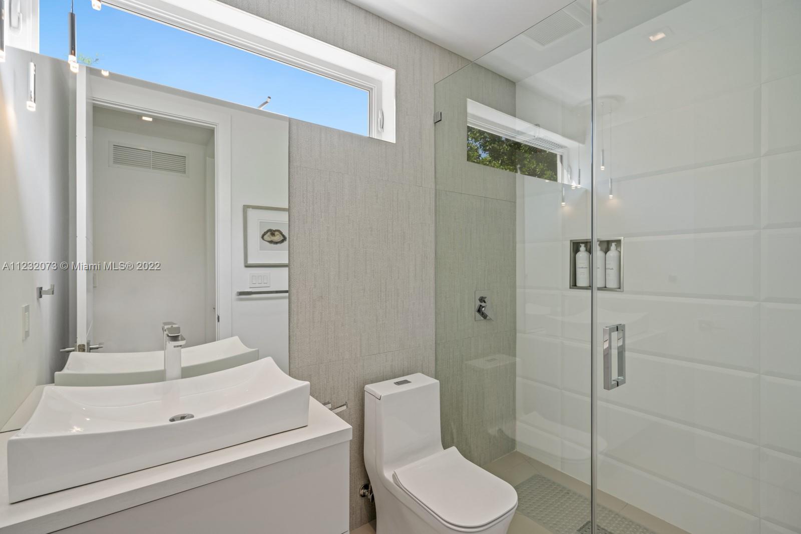 4610 Alton Road Miami Beach, FL 33140 - Photo 23 of 38 a bathroom with a toilet sink and shower