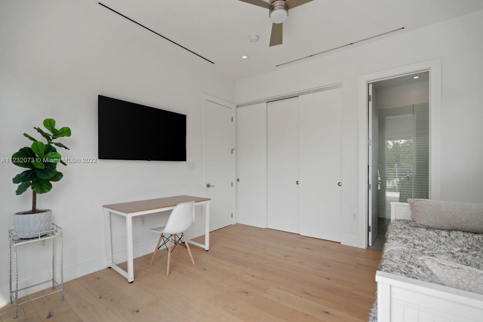 4610 Alton Road Miami Beach, FL 33140 - Photo 28 of 38 a living room with furniture and a flat screen tv