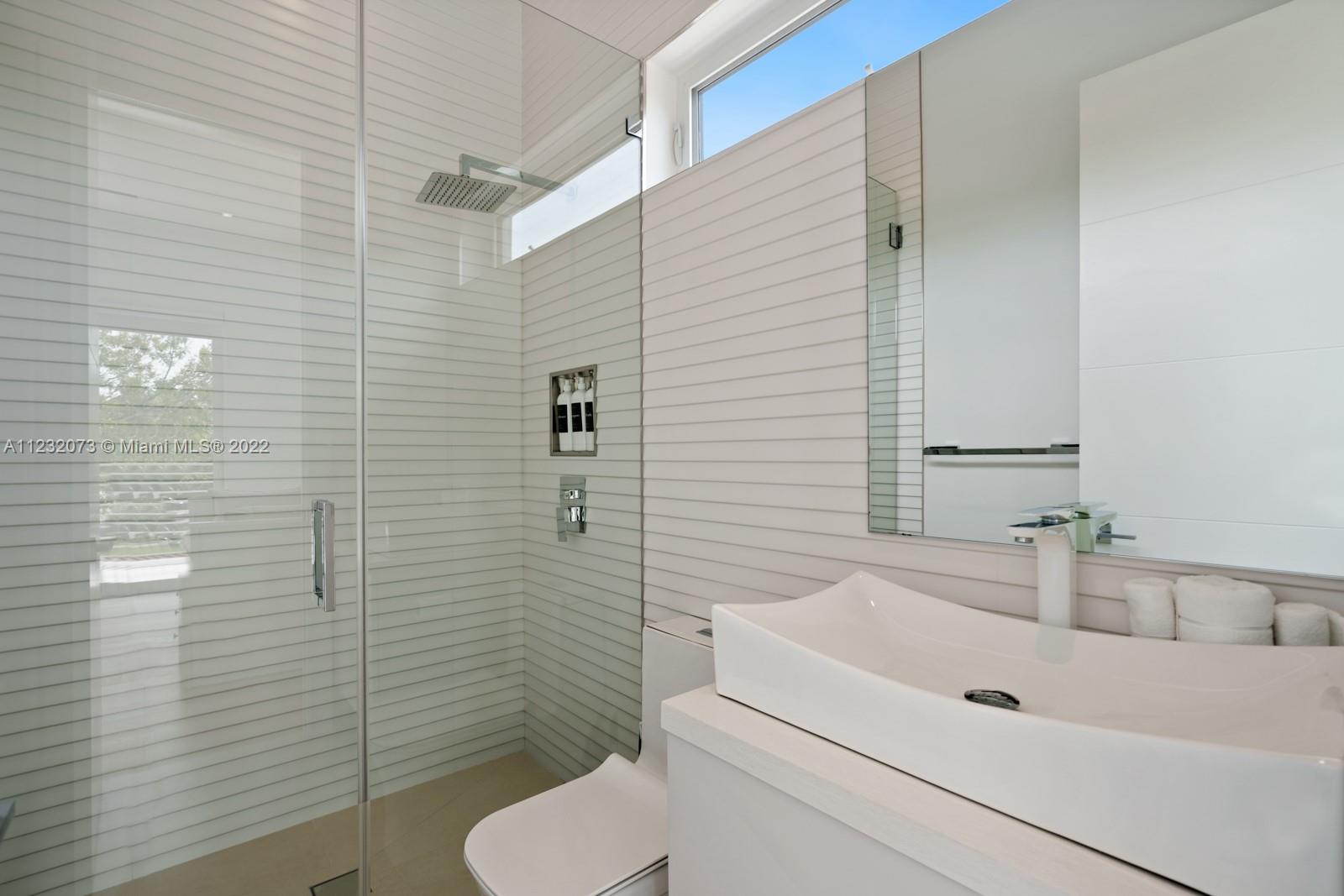 4610 Alton Road Miami Beach, FL 33140 - Photo 29 of 38 a bathroom with a sink a toilet and shower