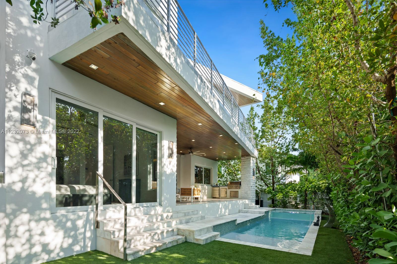 4610 Alton Road Miami Beach, FL 33140 - Photo 30 of 38 a front view of a house with a yard