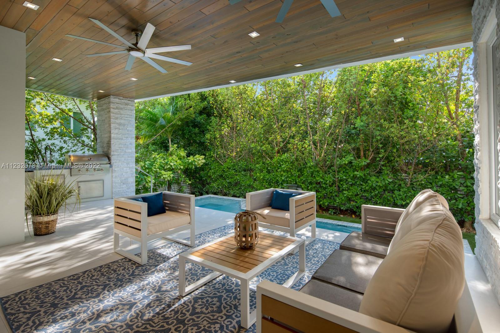 4610 Alton Road Miami Beach, FL 33140 - Photo 32 of 38 a outdoor living space with furniture and garden view