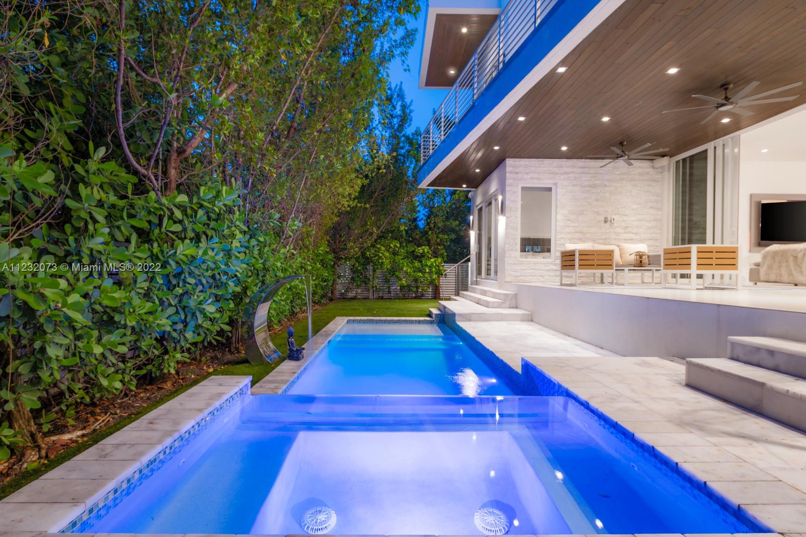 4610 Alton Road Miami Beach, FL 33140 - Photo 33 of 38 a swimming pool with yard in front of it