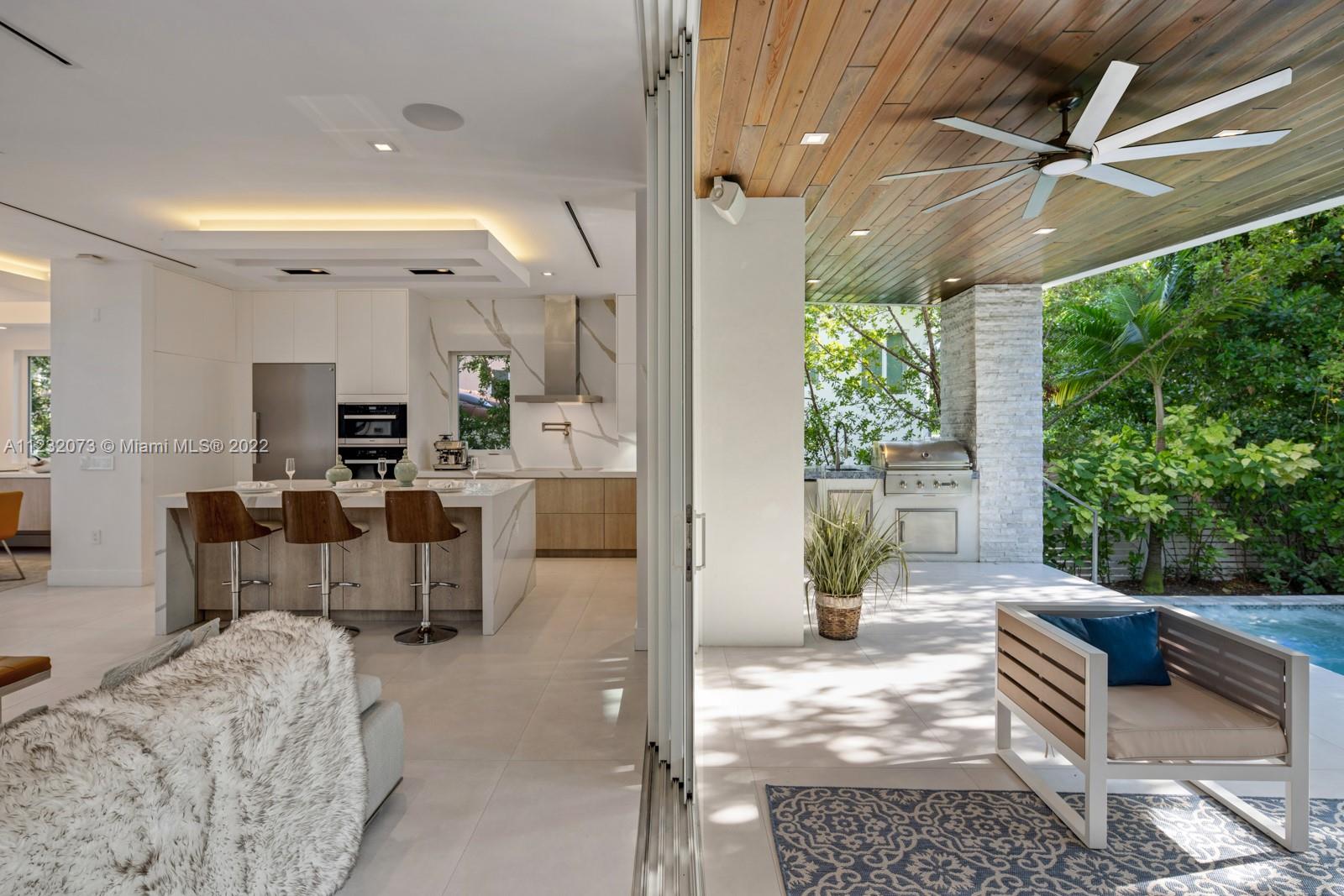 4610 Alton Road Miami Beach, FL 33140 - Photo 34 of 38 a living room with furniture and a large window