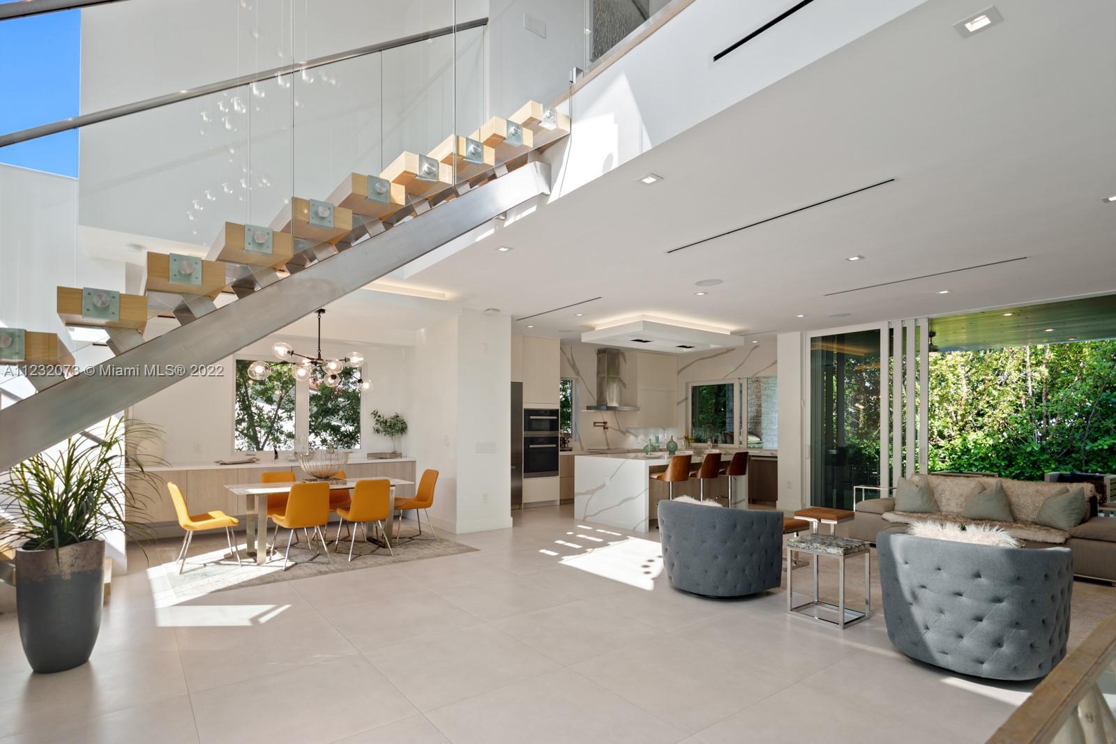 4610 Alton Road Miami Beach, FL 33140 - Photo 4 of 38 a room with furniture and a chandelier