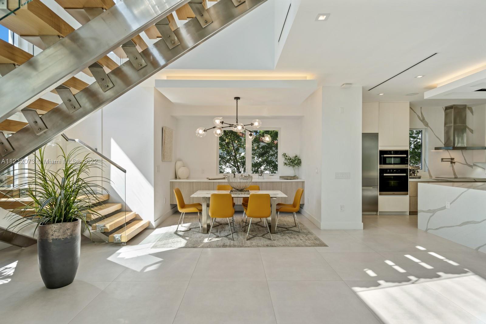 4610 Alton Road Miami Beach, FL 33140 - Photo 5 of 38 a living room with furniture a dining table and chairs