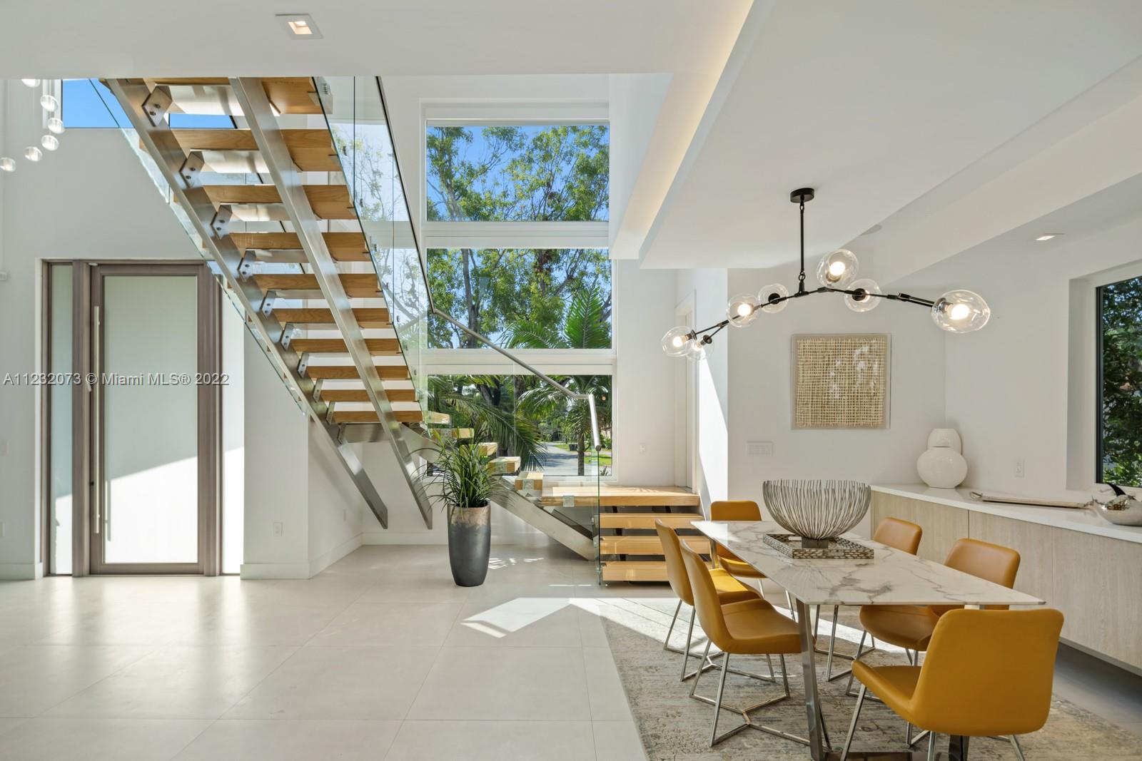4610 Alton Road Miami Beach, FL 33140 - Photo 6 of 38 a living room with furniture and a potted plant