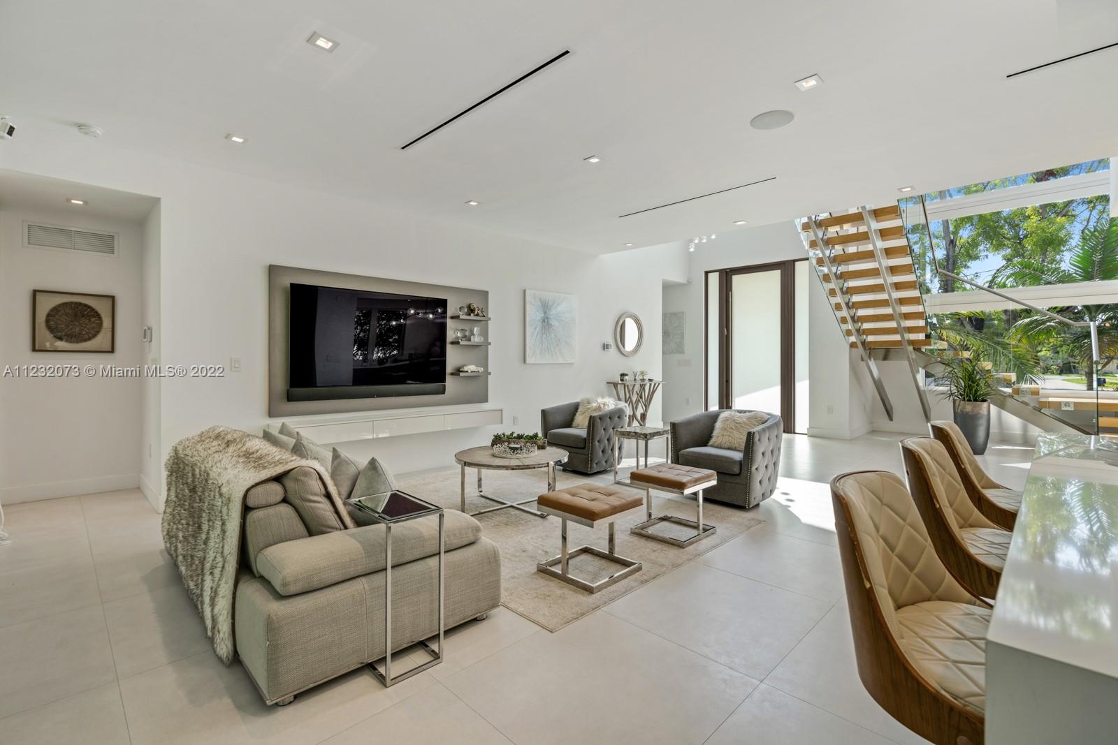 4610 Alton Road Miami Beach, FL 33140 - Photo 10 of 38 a living room with furniture and a flat screen tv