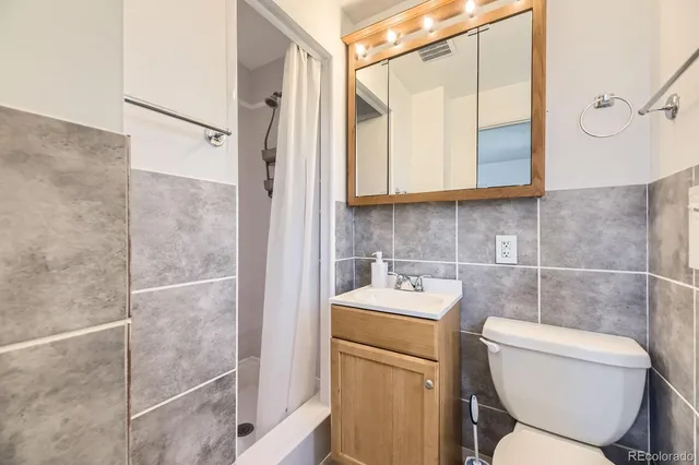 a bathroom with a toilet sink and shower