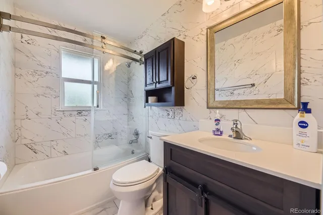 a bathroom with a sink a toilet and bathtub