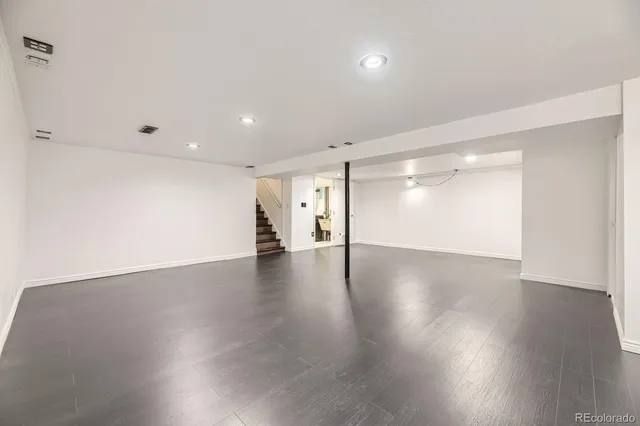 a view of a room with wooden floor