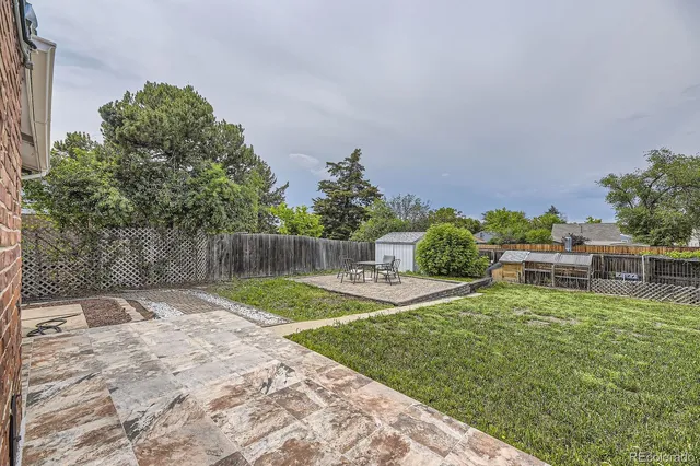 a view of a house with backyard sitting area and garden