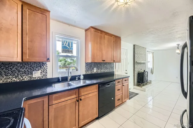 a kitchen with stainless steel appliances a sink stove and cabinets