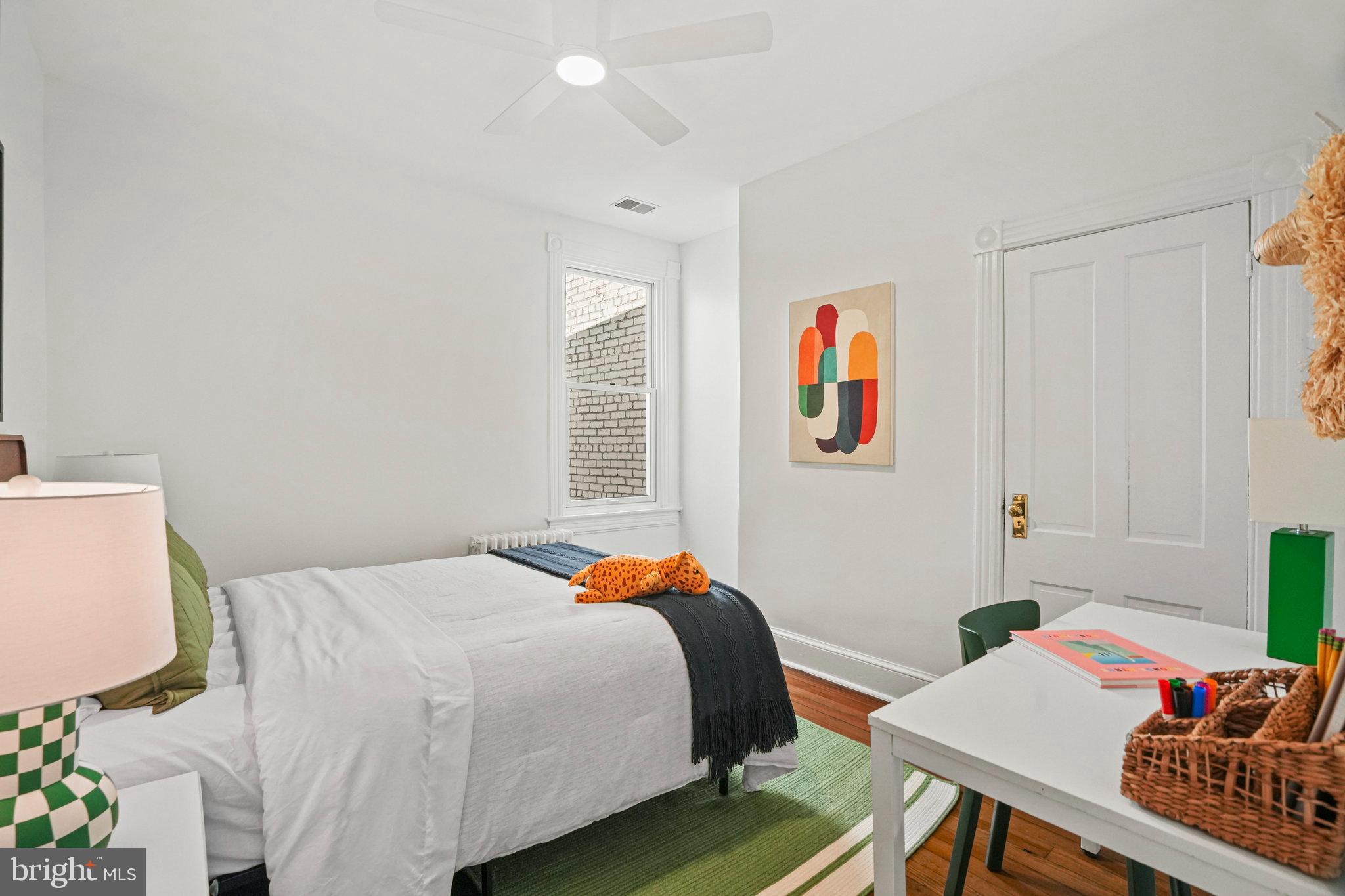 655 F Street Northeast Washington, DC 20002 - Photo 14 of 24 a bedroom with a bed and a table in it