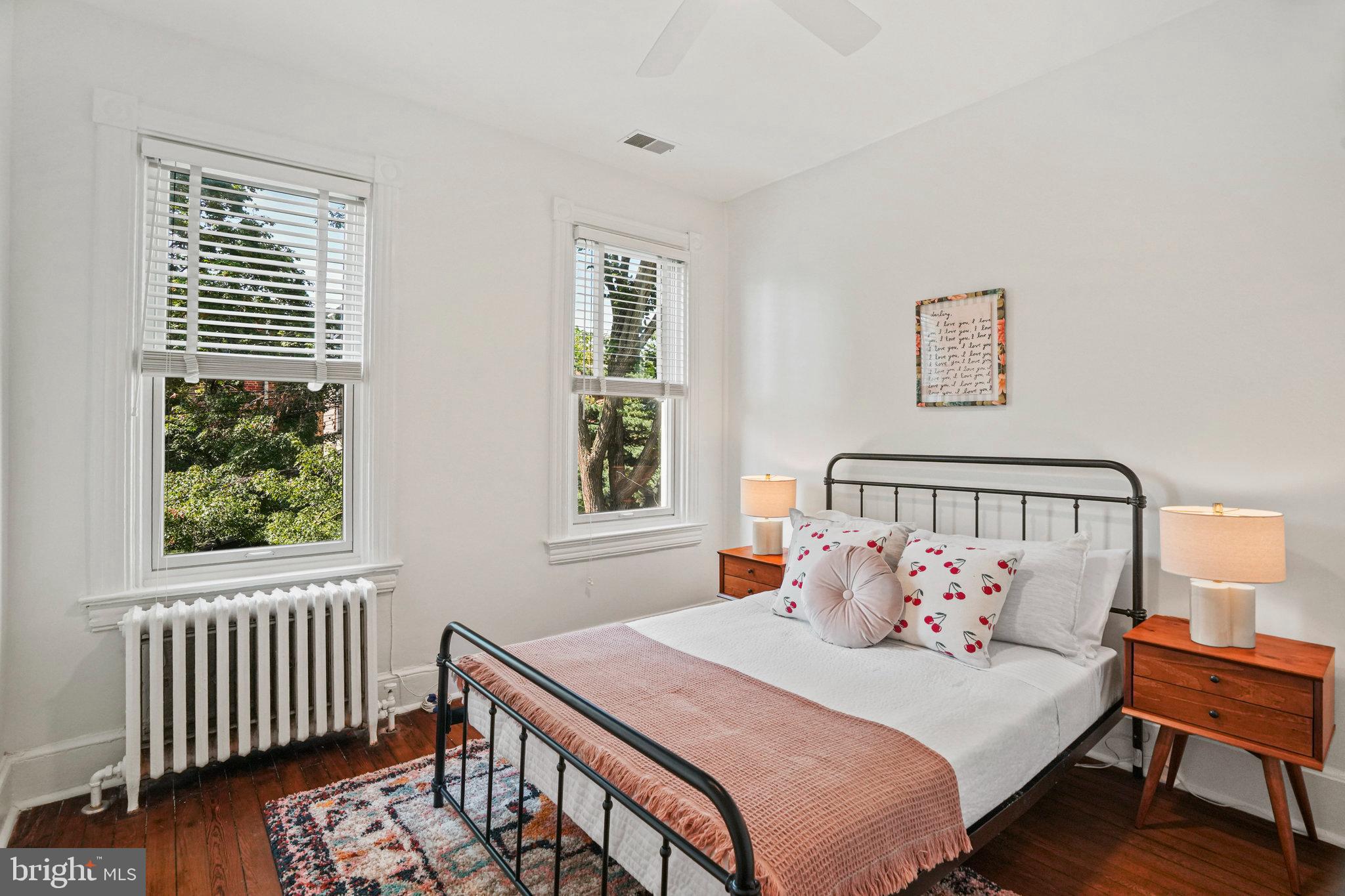 655 F Street Northeast Washington, DC 20002 - Photo 16 of 24 a bedroom with a bed and a window with wooden floor