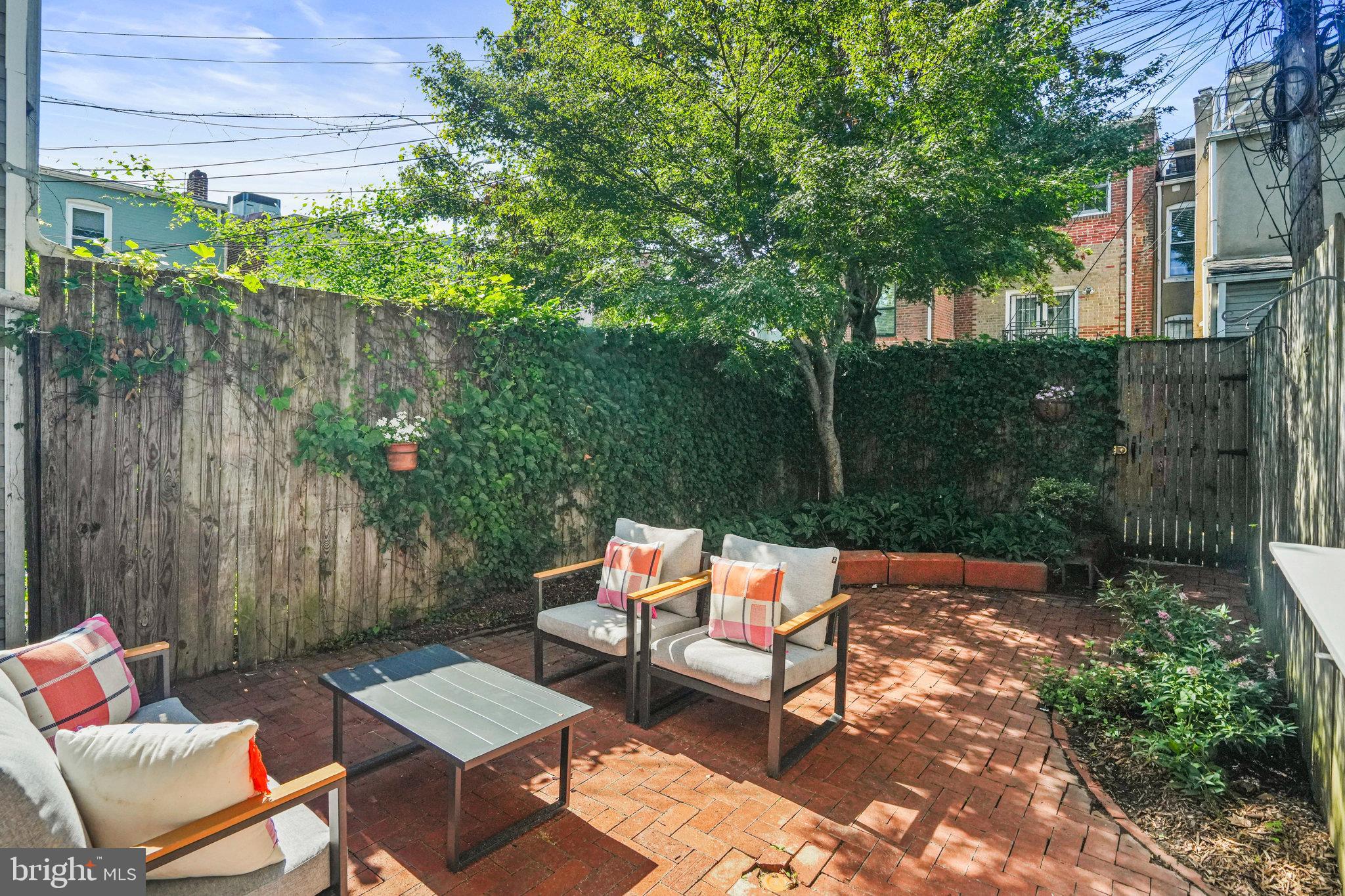 655 F Street Northeast Washington, DC 20002 - Photo 19 of 24 a backyard of a house with table and chairs
