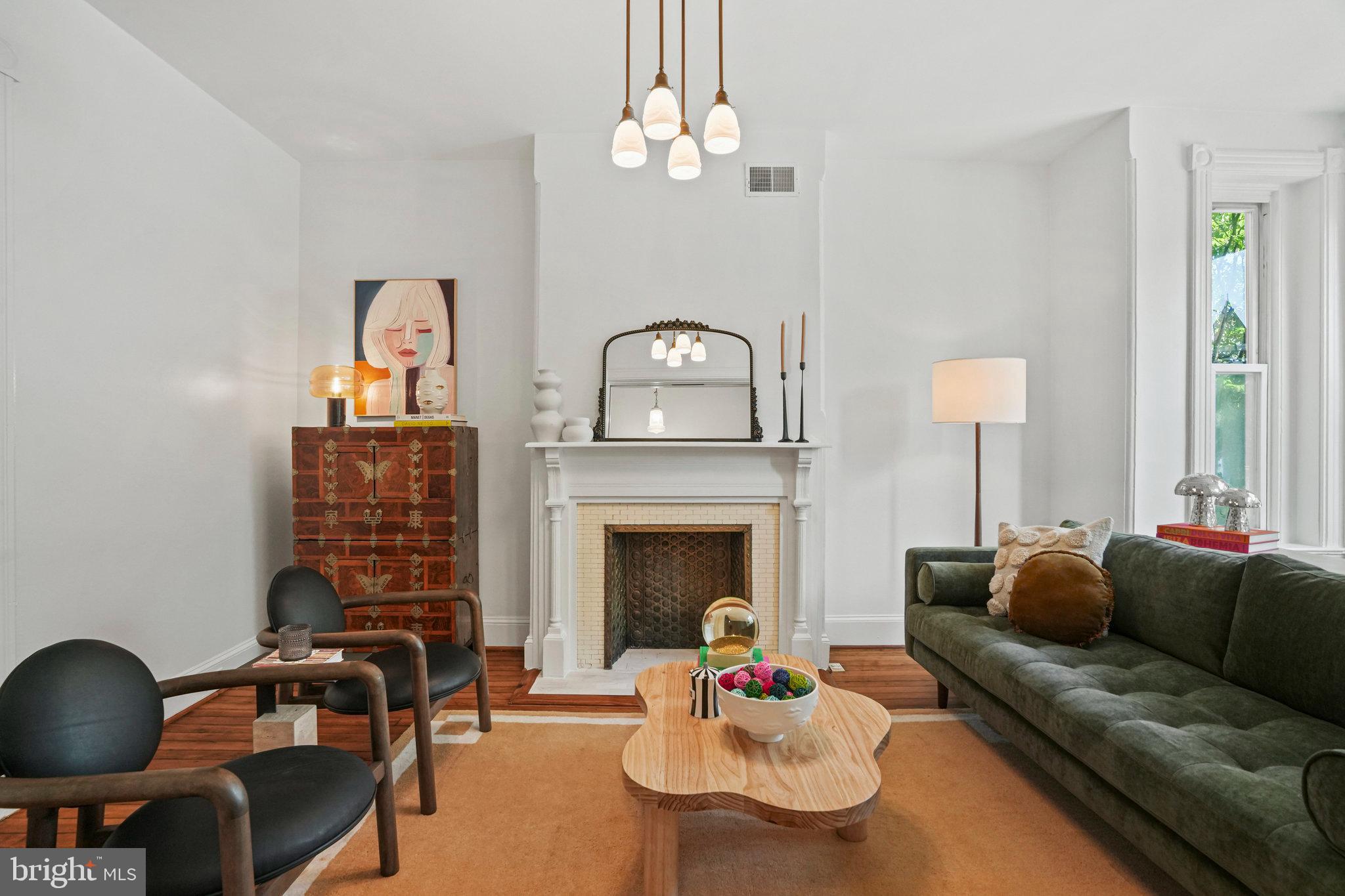 655 F Street Northeast Washington, DC 20002 - Photo 3 of 24 a living room with furniture a fireplace and a chandelier