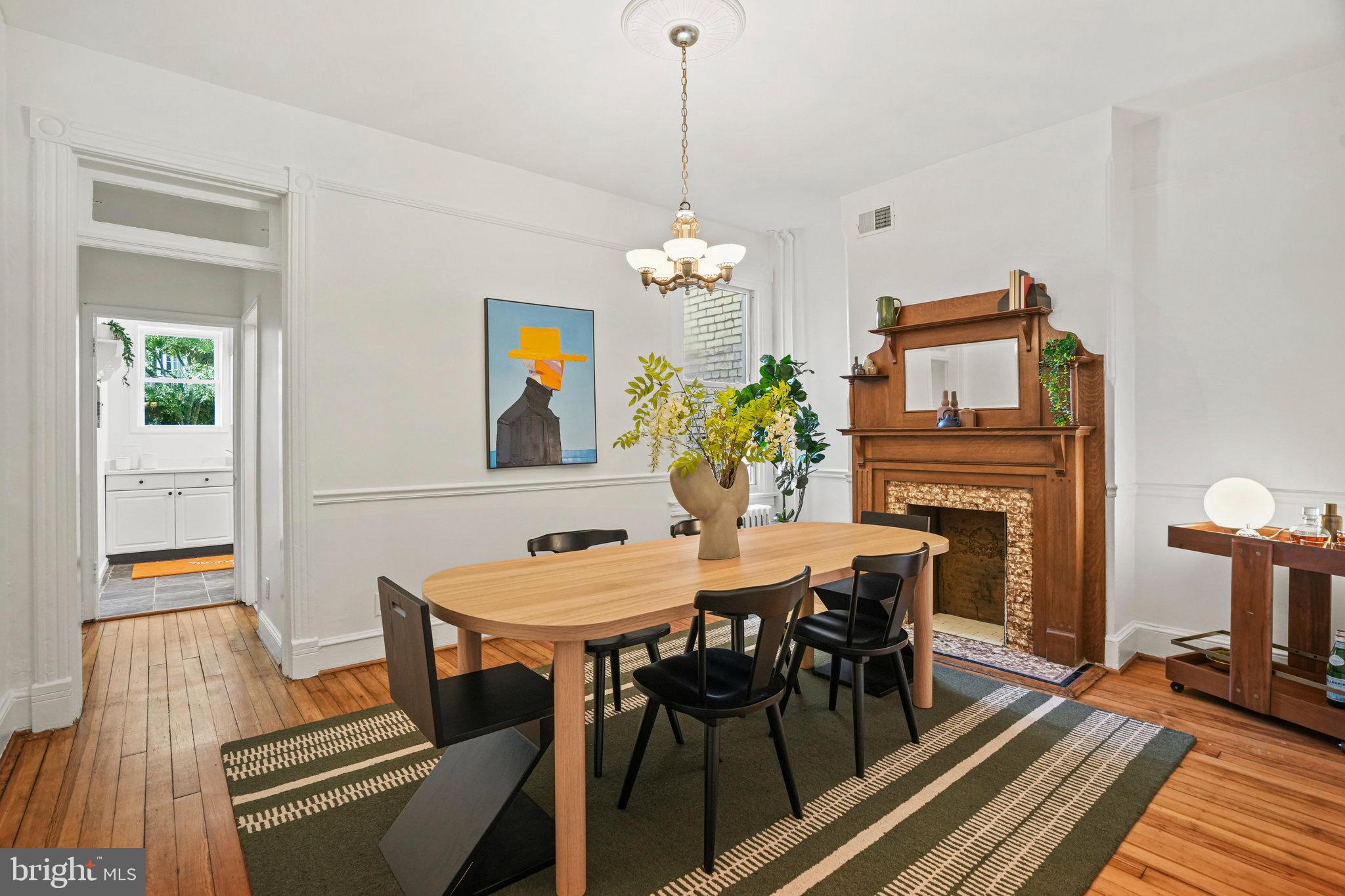 655 F Street Northeast Washington, DC 20002 - Photo 6 of 24 a view of a dining room with furniture wooden floor and a chandelier