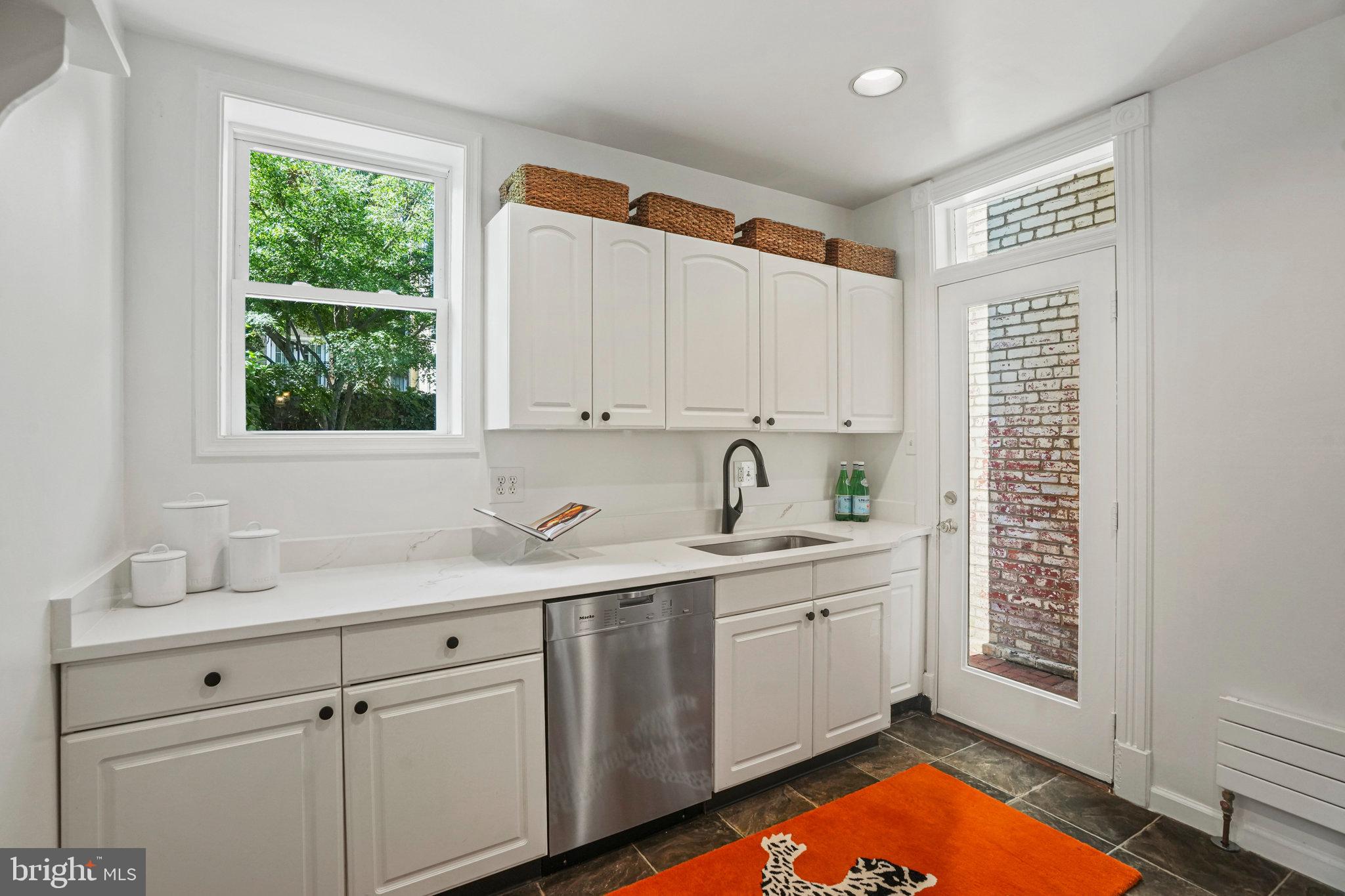 655 F Street Northeast Washington, DC 20002 - Photo 7 of 24 a kitchen with a sink cabinets window and appliances