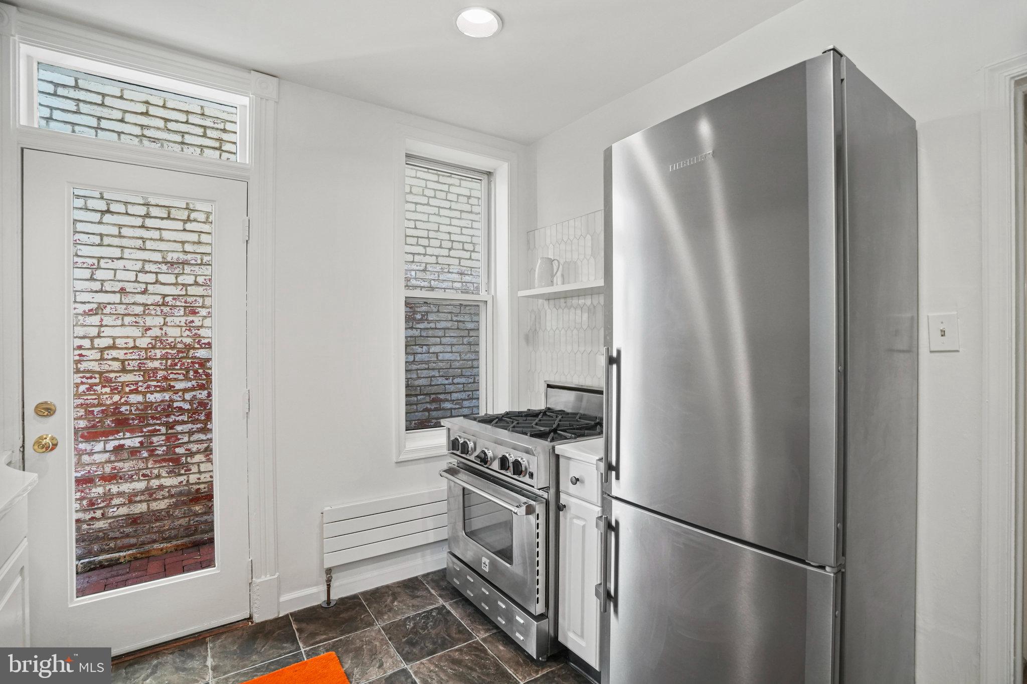 655 F Street Northeast Washington, DC 20002 - Photo 8 of 24 a kitchen with stainless steel appliances a refrigerator and a stove top oven