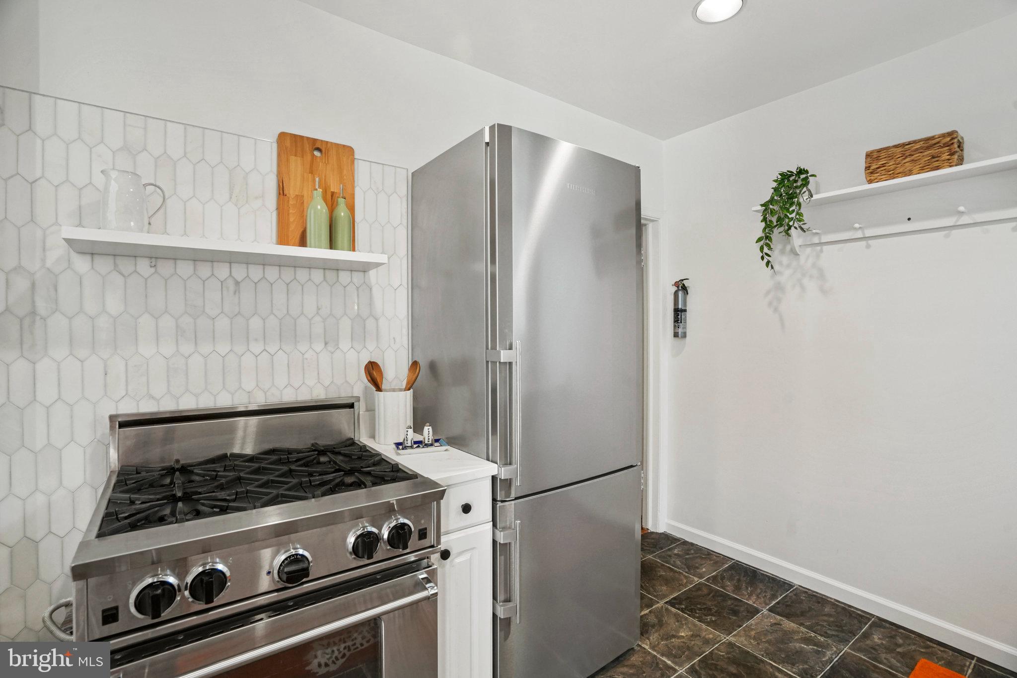 655 F Street Northeast Washington, DC 20002 - Photo 9 of 24 a stove top oven sitting inside of a kitchen