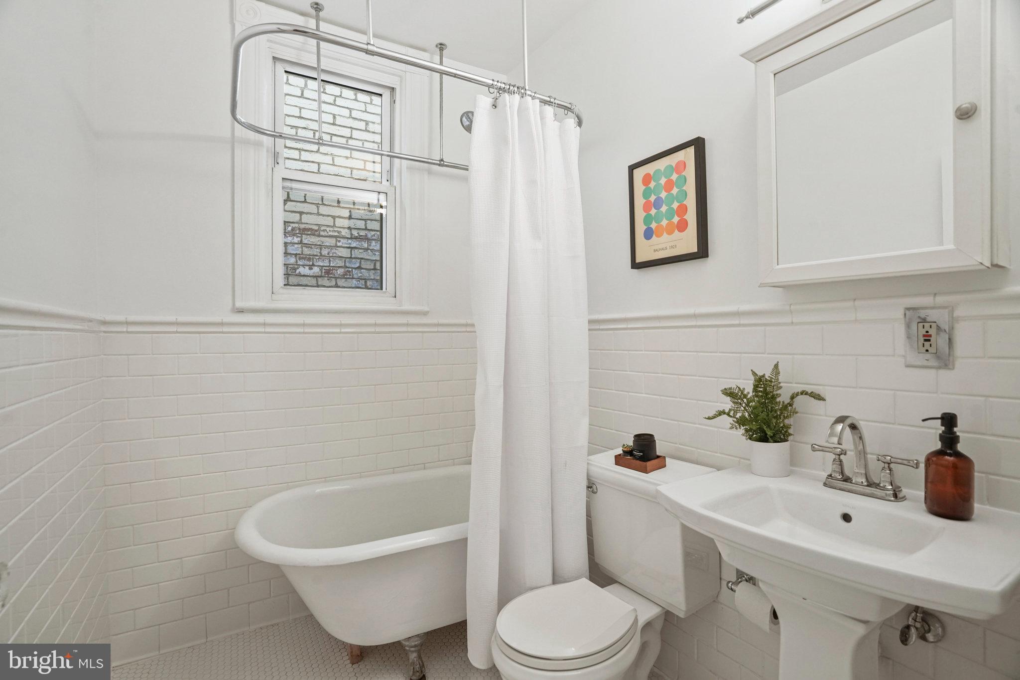 655 F Street Northeast Washington, DC 20002 - Photo 10 of 24 a bathroom with a sink toilet and shower