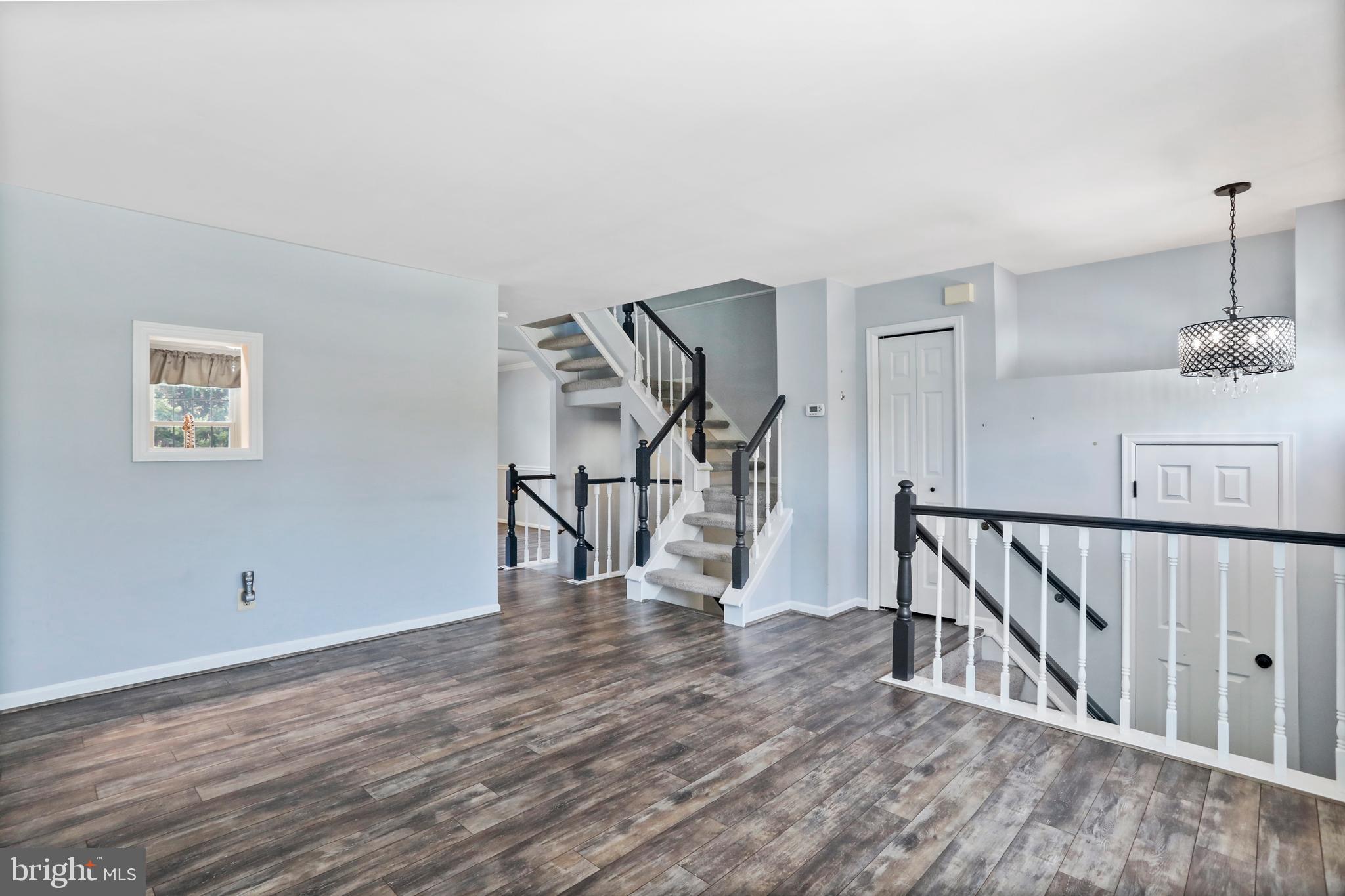 21799 Leatherleaf Circle Sterling, VA 20164 - Photo 7 of 45 a view of an empty room with wooden floor