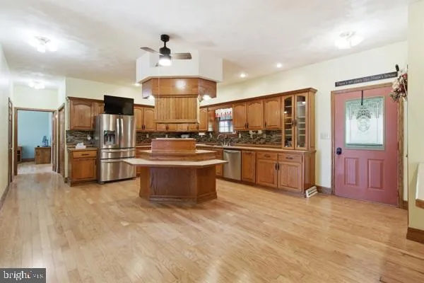 a kitchen with refrigerator and cabinets