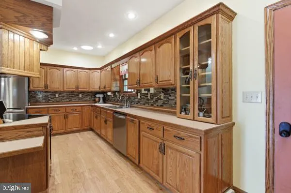 a large kitchen with a large window and stainless steel appliances